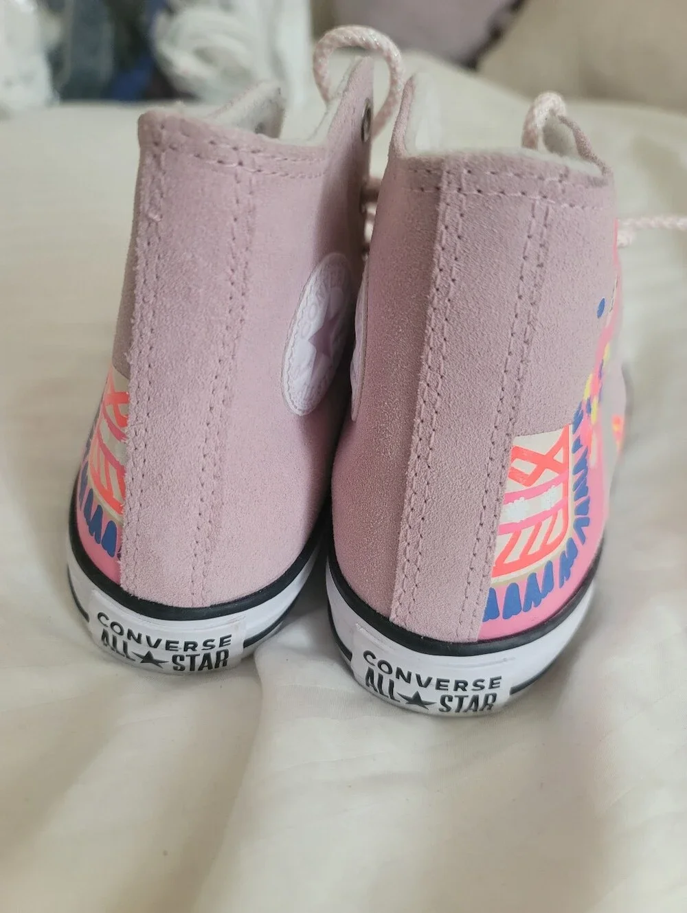 Pink Converse Chuck Taylor All Star High sneakers feature a playful llama